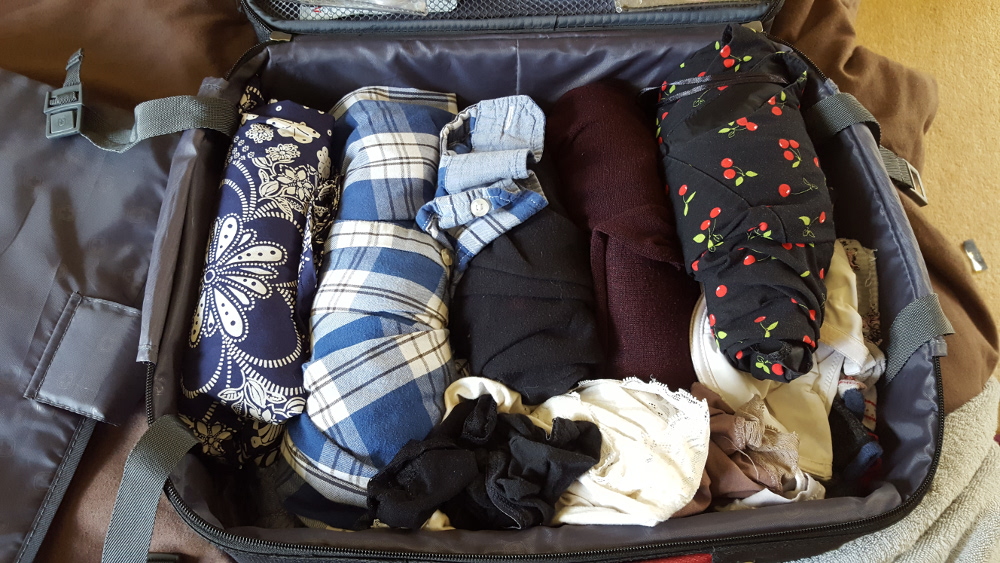 Roll clothes to make them fit into your suitcase.